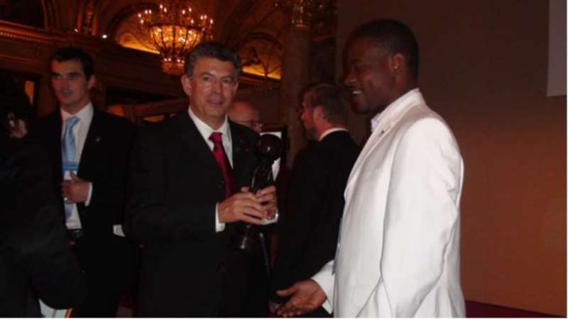 Mr. Patrick Arthur Director of Communication International Children Games Ghana presenting the award to His Serene Highness Prince Albert 11 of Monaco which was  received on his behalf by Joel Bouzou President of Peace and Sports Forum at the 2008 Peace and Sports Forum in Monaco.
